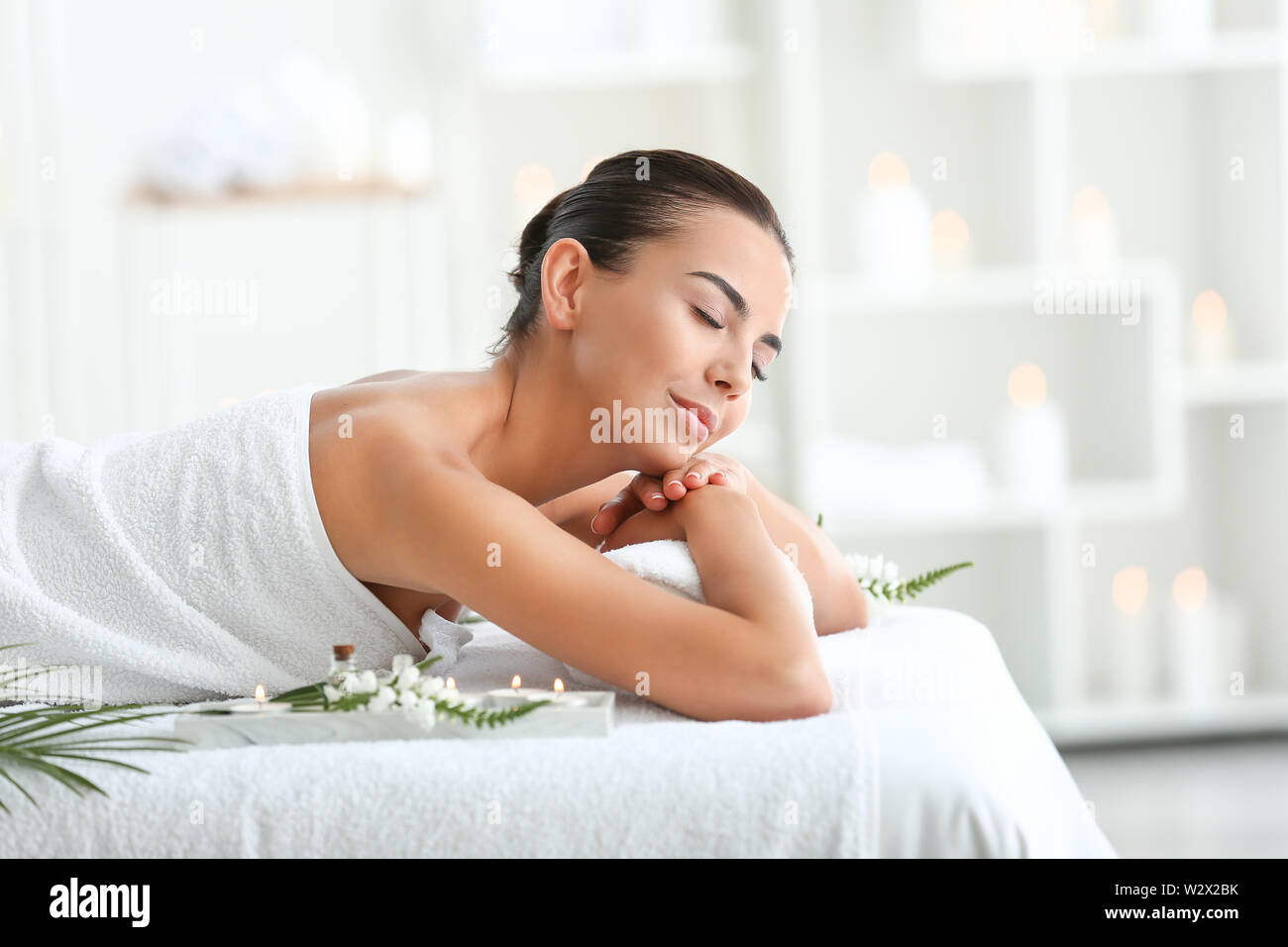 Beautiful young woman relaxing in spa salon Stock Photo - Alamy