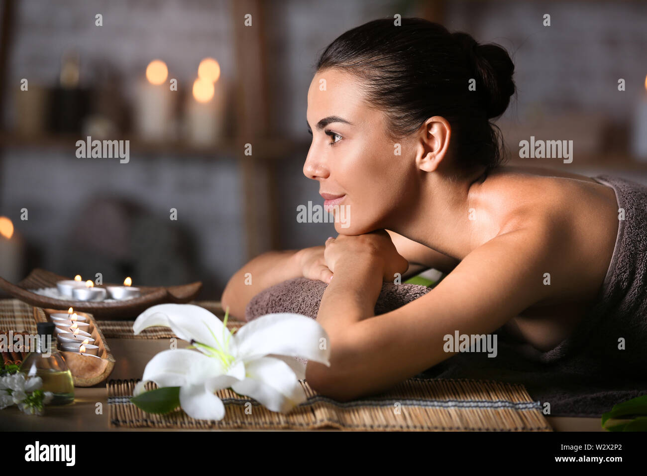 Beautiful young woman relaxing in spa salon Stock Photo - Alamy