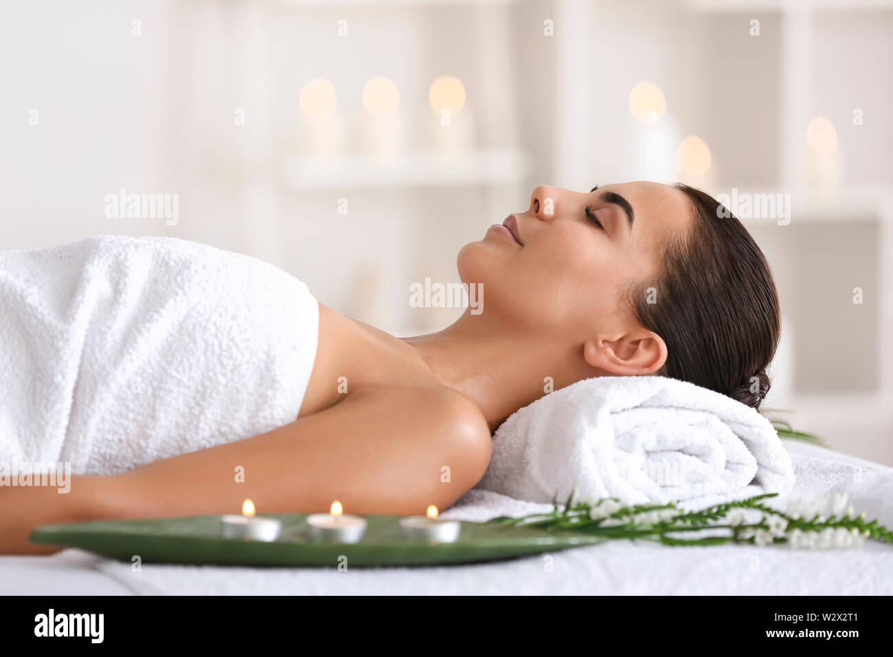 Beautiful young woman relaxing in spa salon Stock Photo - Alamy