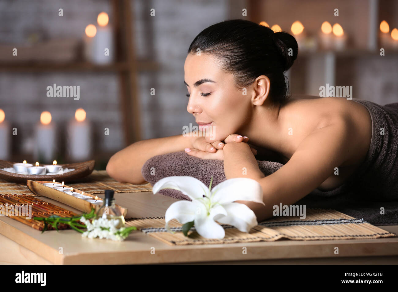Beautiful young woman relaxing in spa salon Stock Photo - Alamy