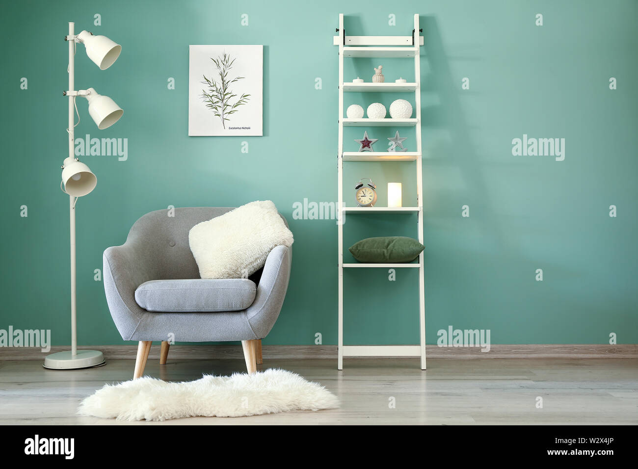 Interior of modern room with armchair, shelf unit and lamp Stock Photo ...