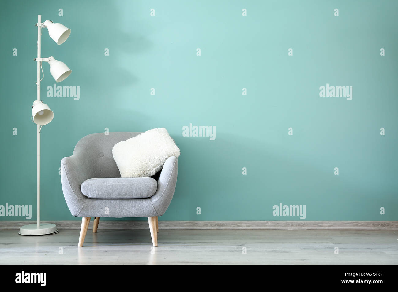 Interior of modern room with armchair and lamp Stock Photo - Alamy