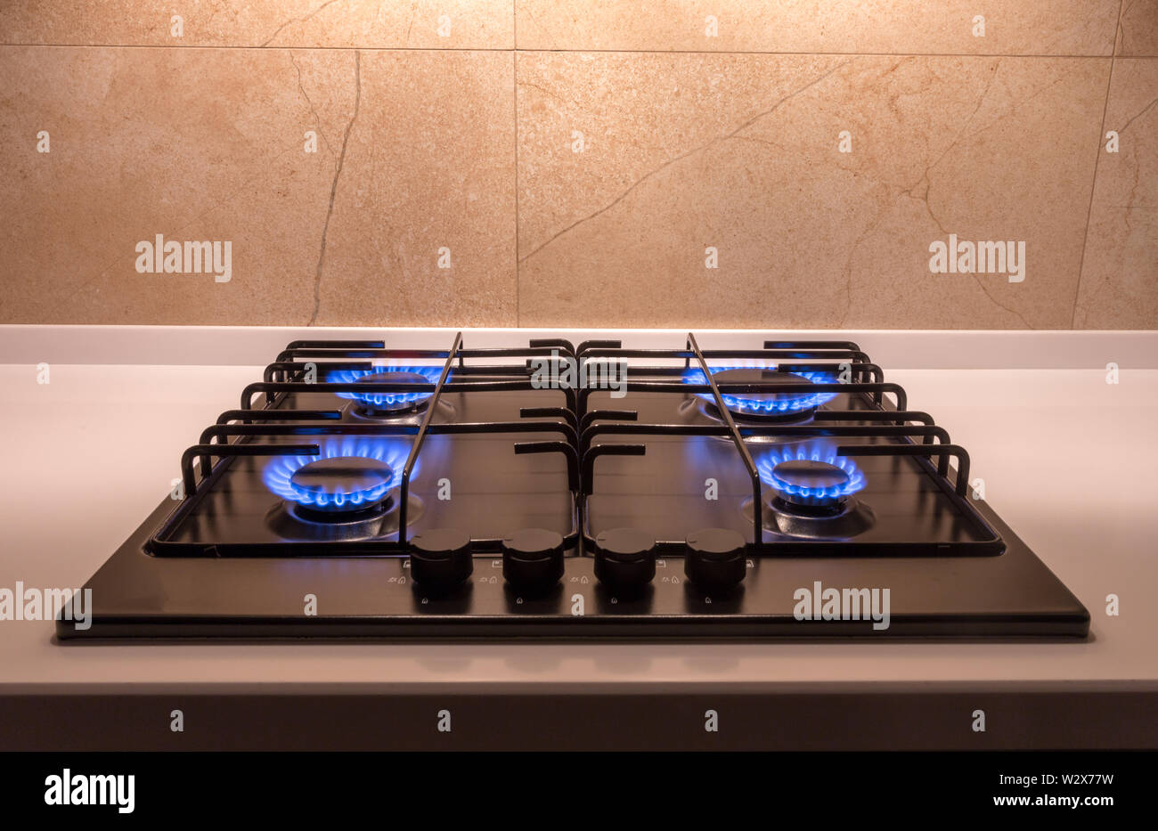 Gas burner on a black modern kitchen stove Stock Photo - Alamy