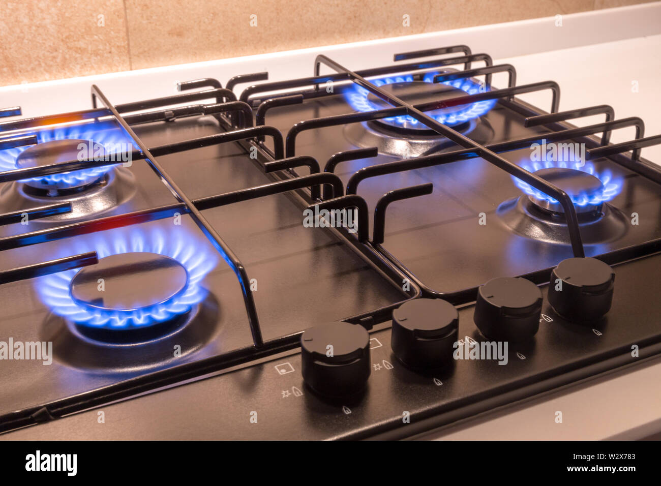 Gas burner on a black modern kitchen stove Stock Photo - Alamy