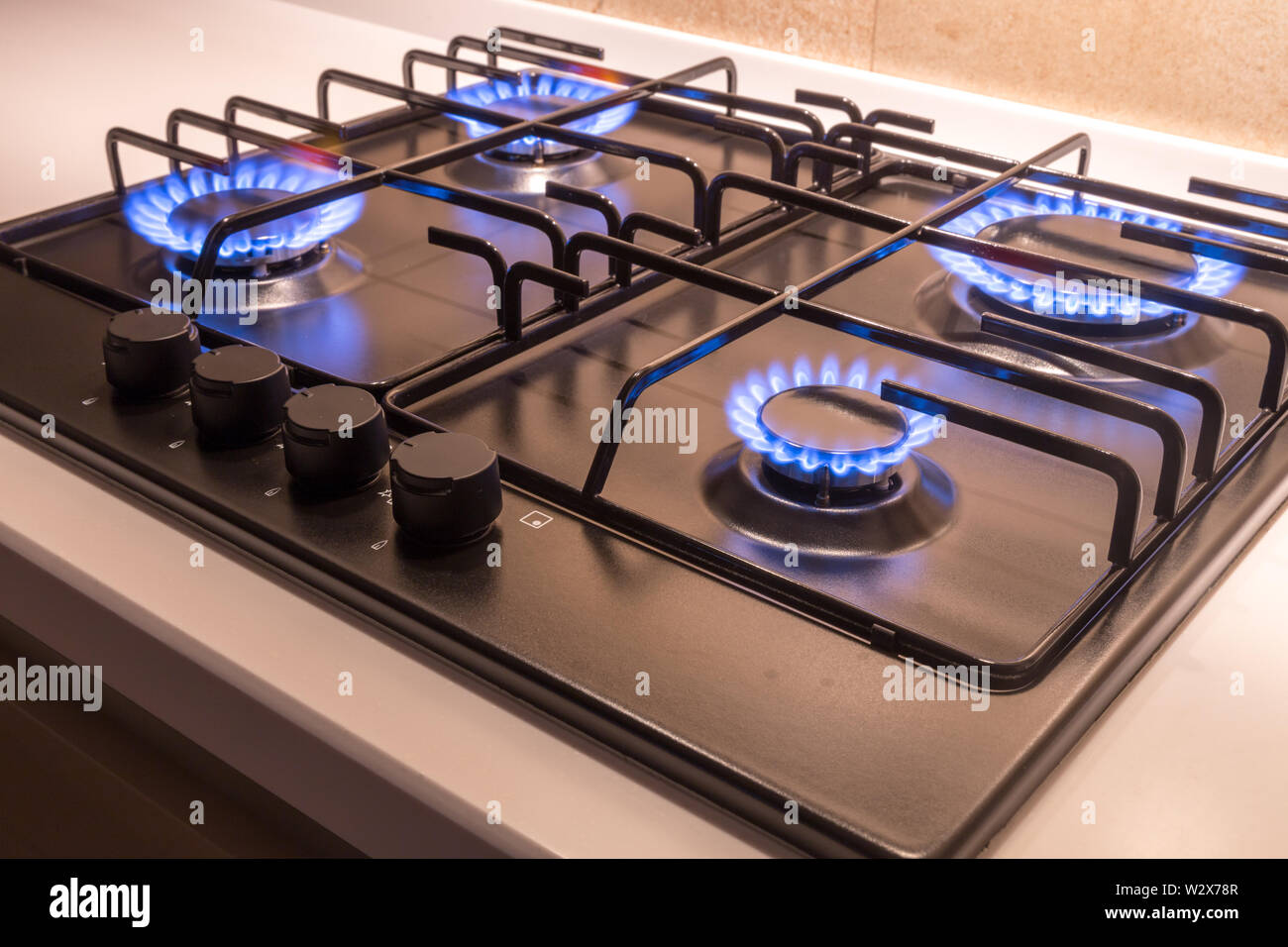Gas burner on a black modern kitchen stove Stock Photo - Alamy