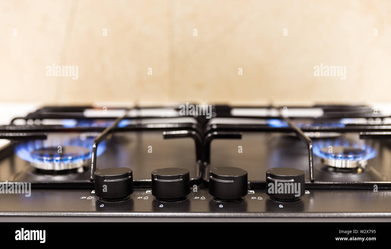 Gas burner on a black modern kitchen stove Stock Photo - Alamy