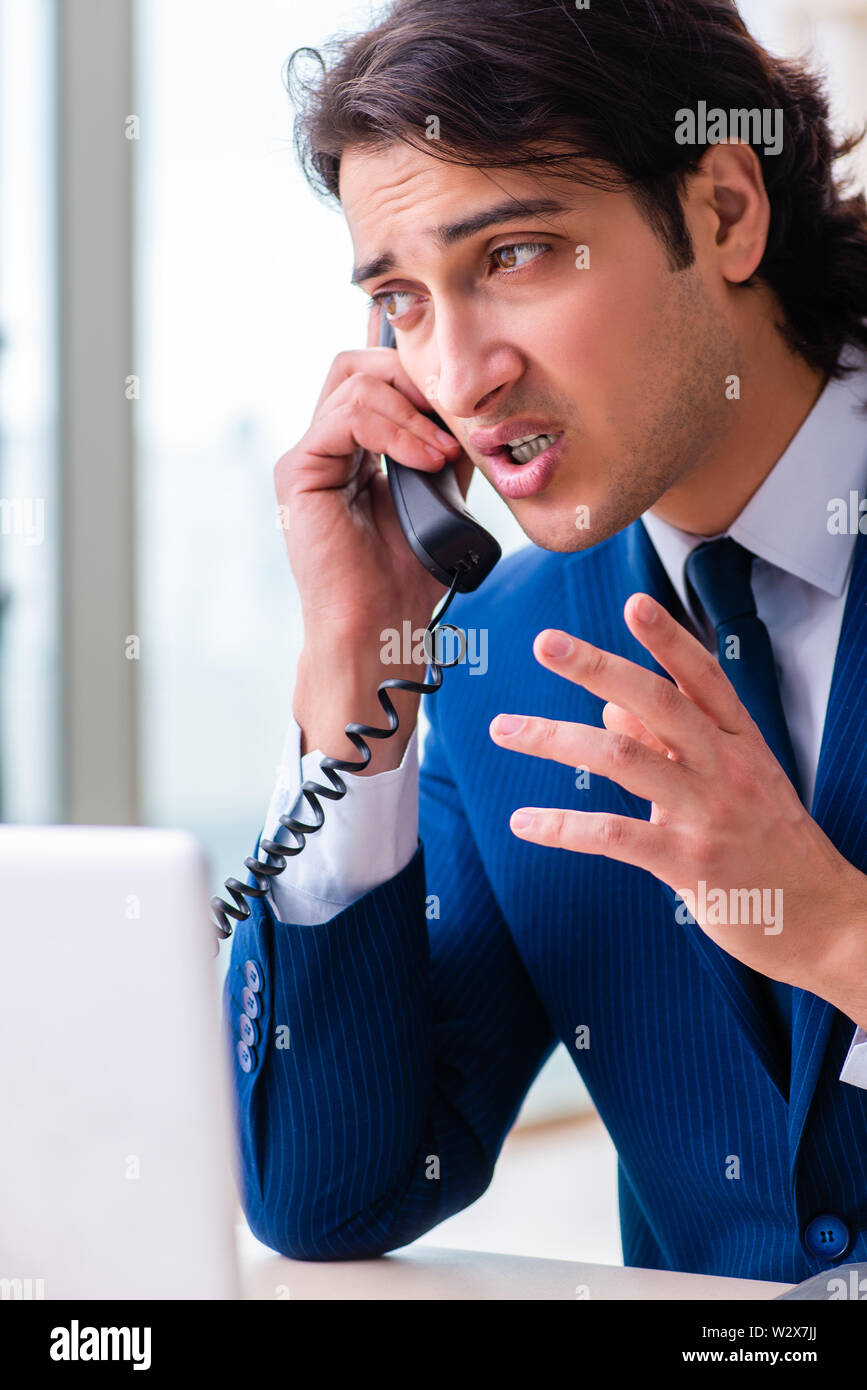 The young businessman sitting and working in the office Stock Photo - Alamy