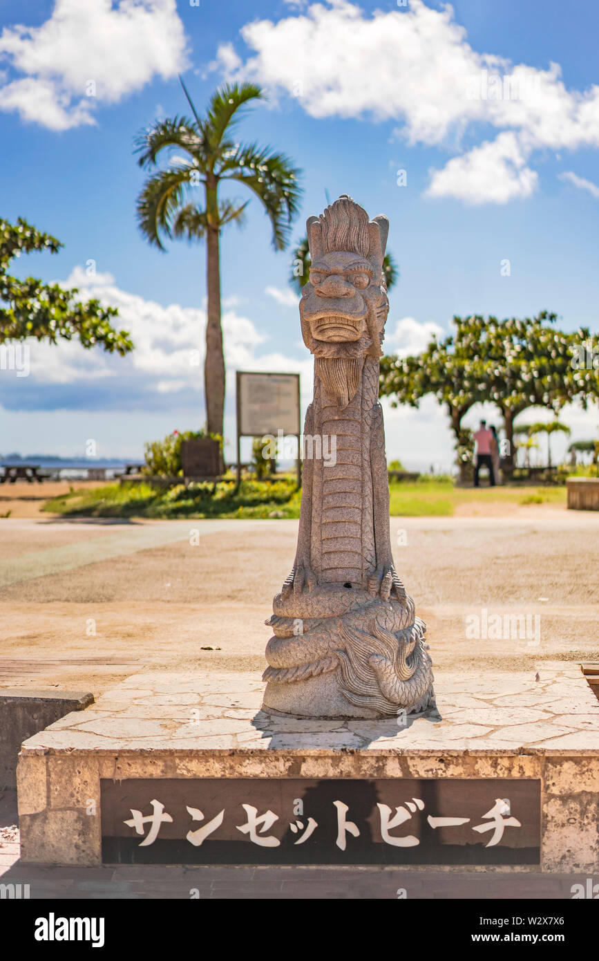Chatan, Japan - September 17 2018: Okinawan Ryukyu dragon stone sculpture where it's inscribed Sunset Beach in japanese alphabet Stock Photo