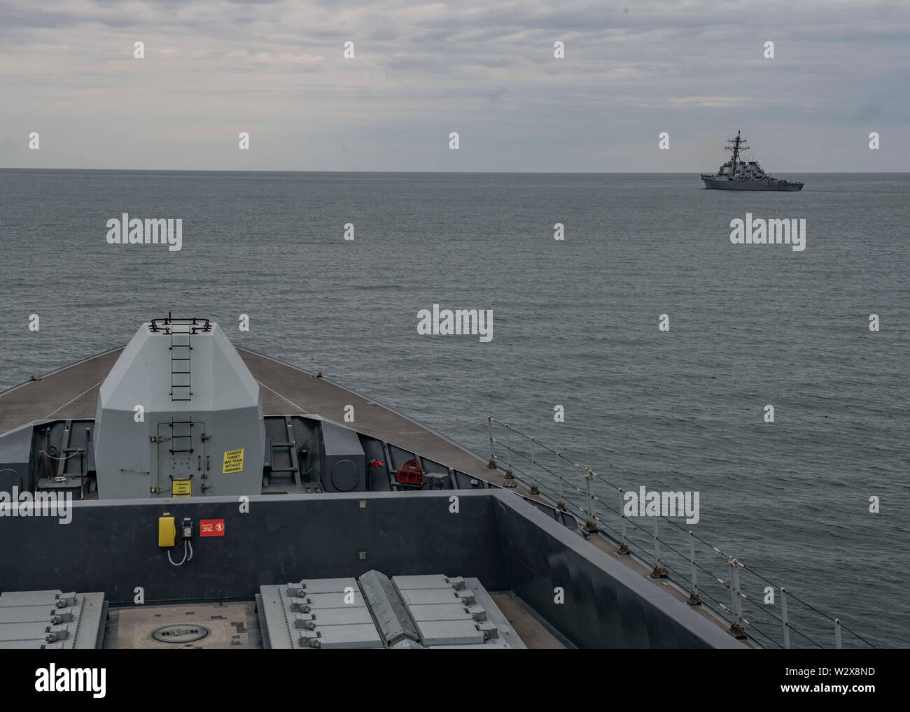 190709-N-TI693-0192    BLACK SEA (July 9, 2019) - The Arleigh Burke-class guided-missile destroyer USS Carney (DDG 64) transits the Black Sea as seen from the bridge aboard the Royal Navy Daring-class air-defence destroyer HMS Duncan (D37) during exercise Sea Breeze 2019, July 9, 2019. Sea Breeze is an annual Ukraine and U.S. co-hosted multinational maritime exercise held in the Black Sea and is designed to enhance interoperability of participating nations to strengthen maritime security and stability within the region. (U.S. Navy photo by Mass Communication Specialist 1st Class Fred Gray IV/R Stock Photo