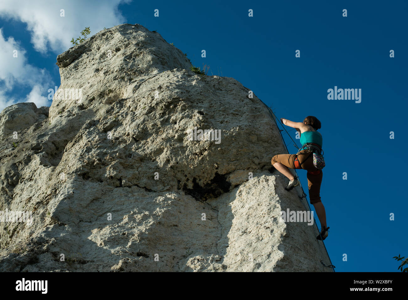 Women climbing vertical wall, Poland Stock Photo