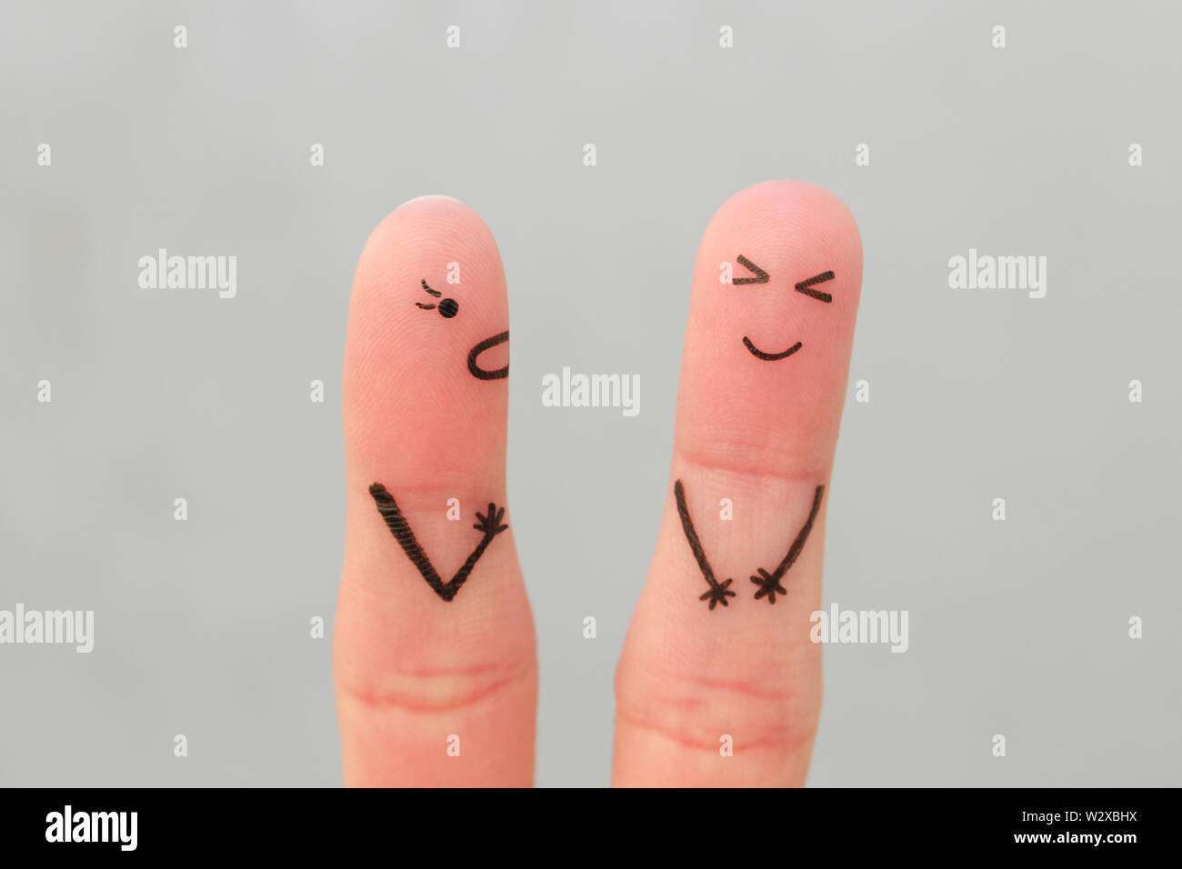 Fingers art of family during quarrel. Concept of wife shouts on husband, man laughs. Stock Photo