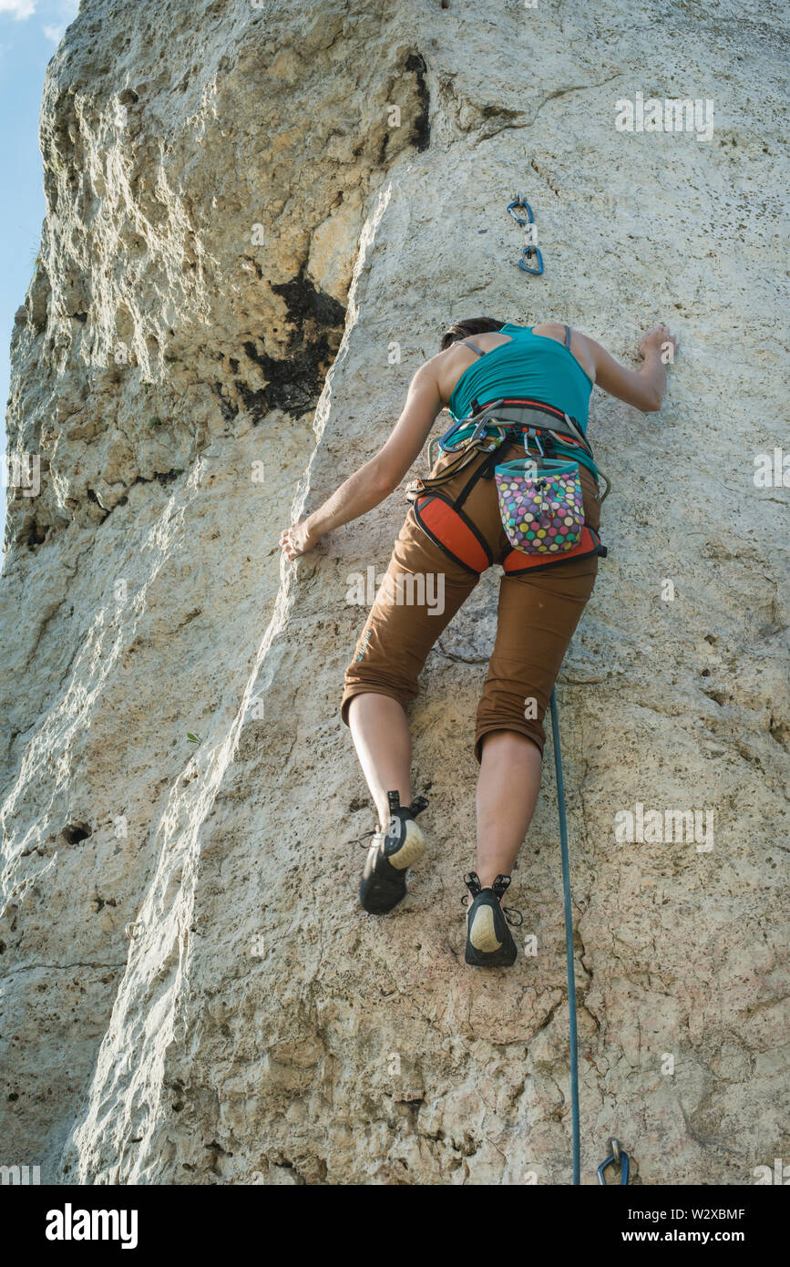 Women climbing vertical wall, Poland Stock Photo