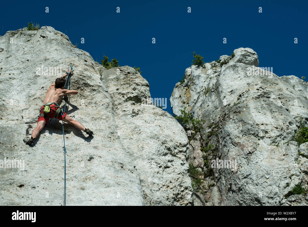 Men climbing vertical wall, Poland Stock Photo Alamy