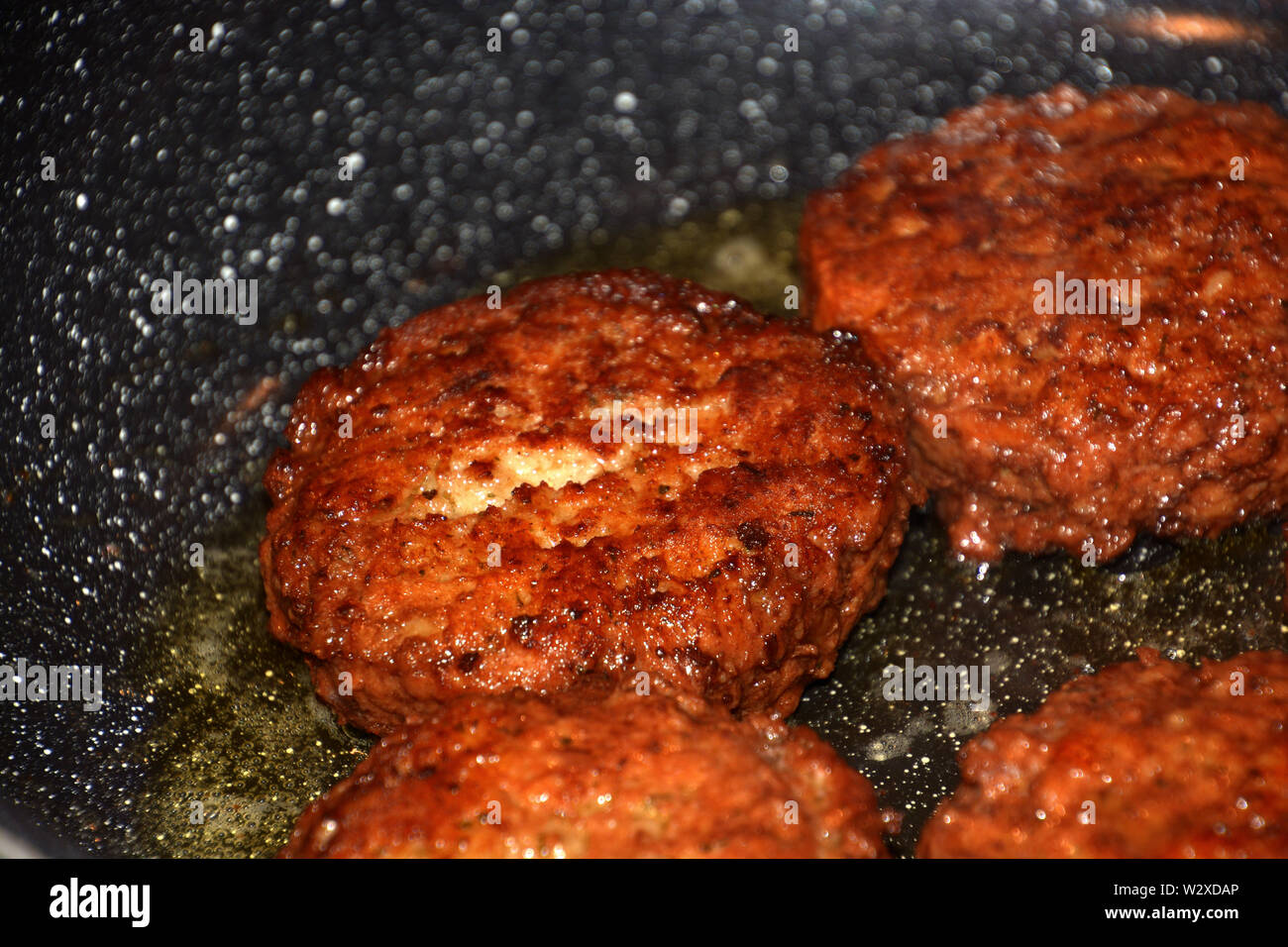 crispy meatballs fry in oil in a pan detail and macro shot, ready to eat meatloaf in a pan Stock Photo