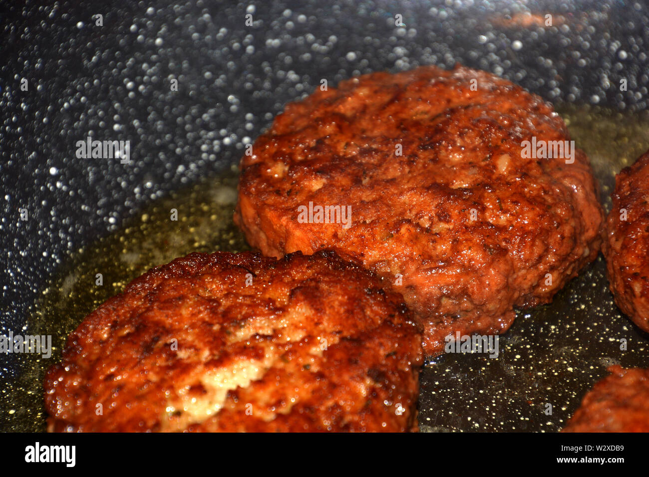 ready to eat crispy meatloaf, crispy meatballs fry in oil in a pan detail and macro shot Stock Photo