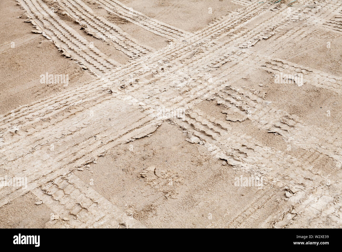 Tire tracks on wet sandy ground, off-road transportation background texture Stock Photo