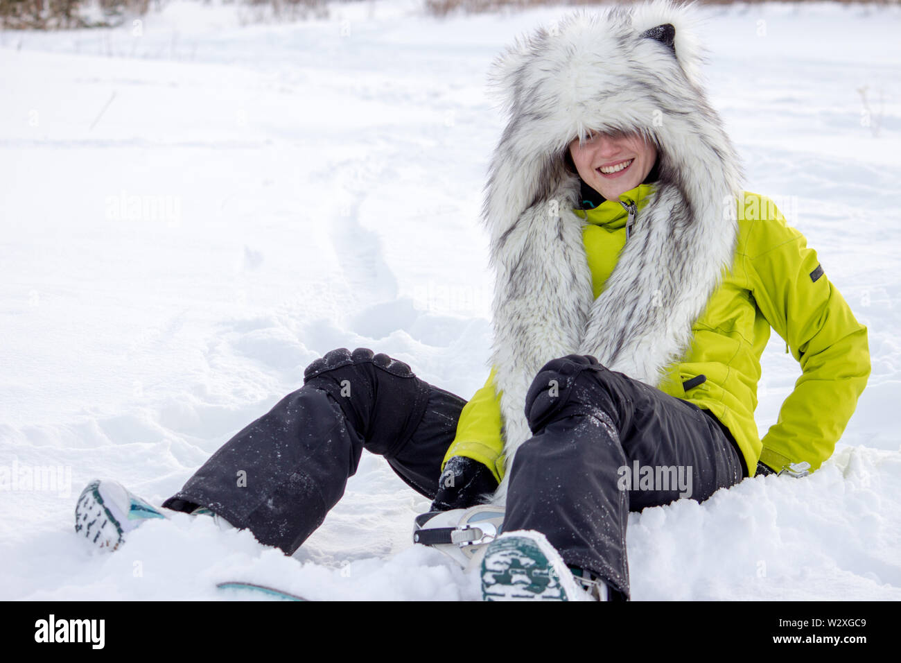 Sports girl in animal hat with ears. Funny snowboarding concept. Stock Photo