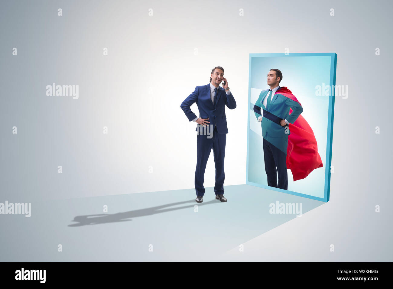 The businessman seeing himself in mirror as superhero Stock Photo - Alamy