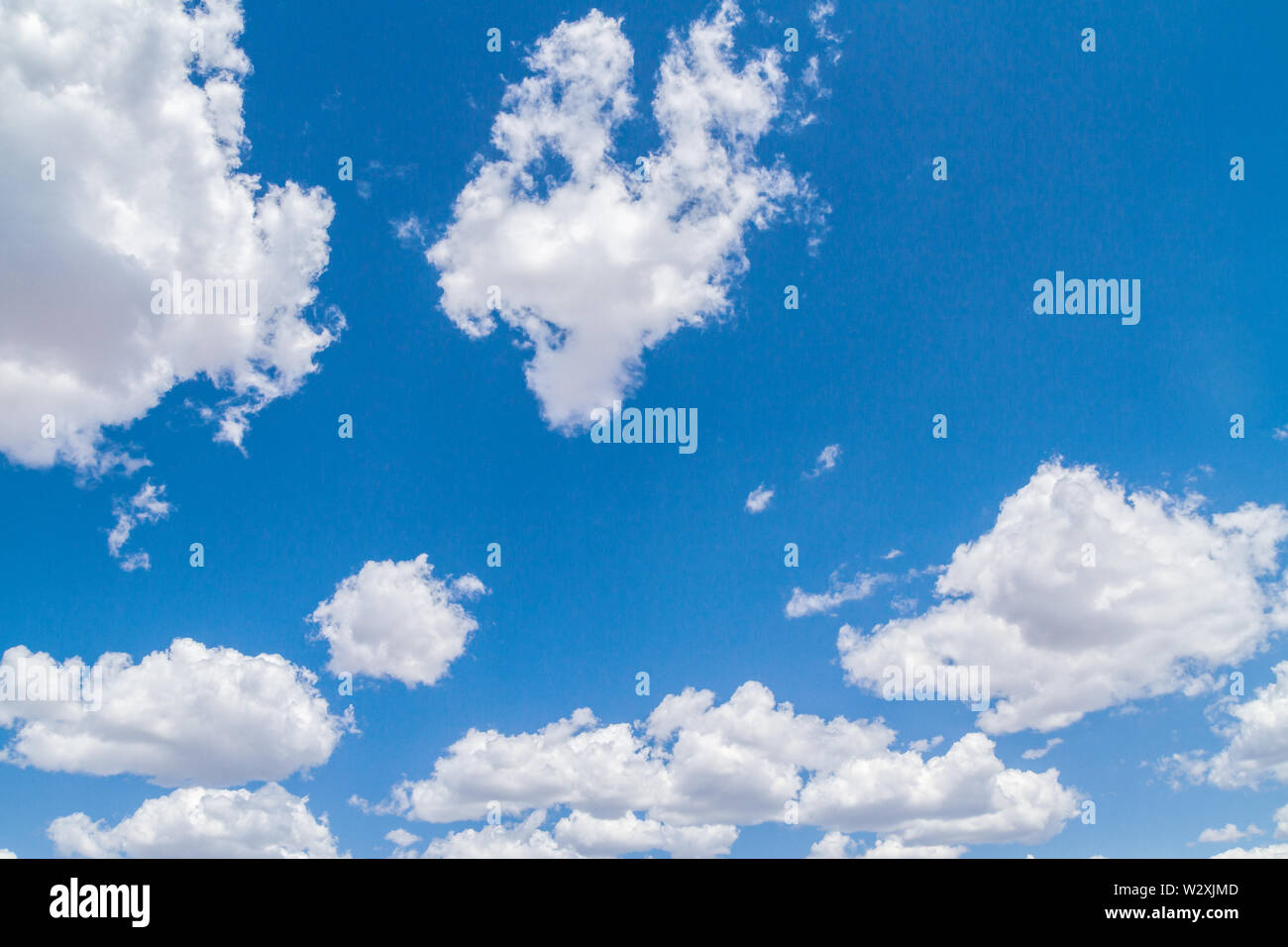 White fluffy clouds in the blue sky in summer Stock Photo - Alamy
