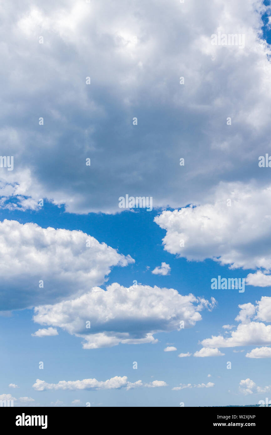 White fluffy clouds in the blue sky in summer Stock Photo - Alamy