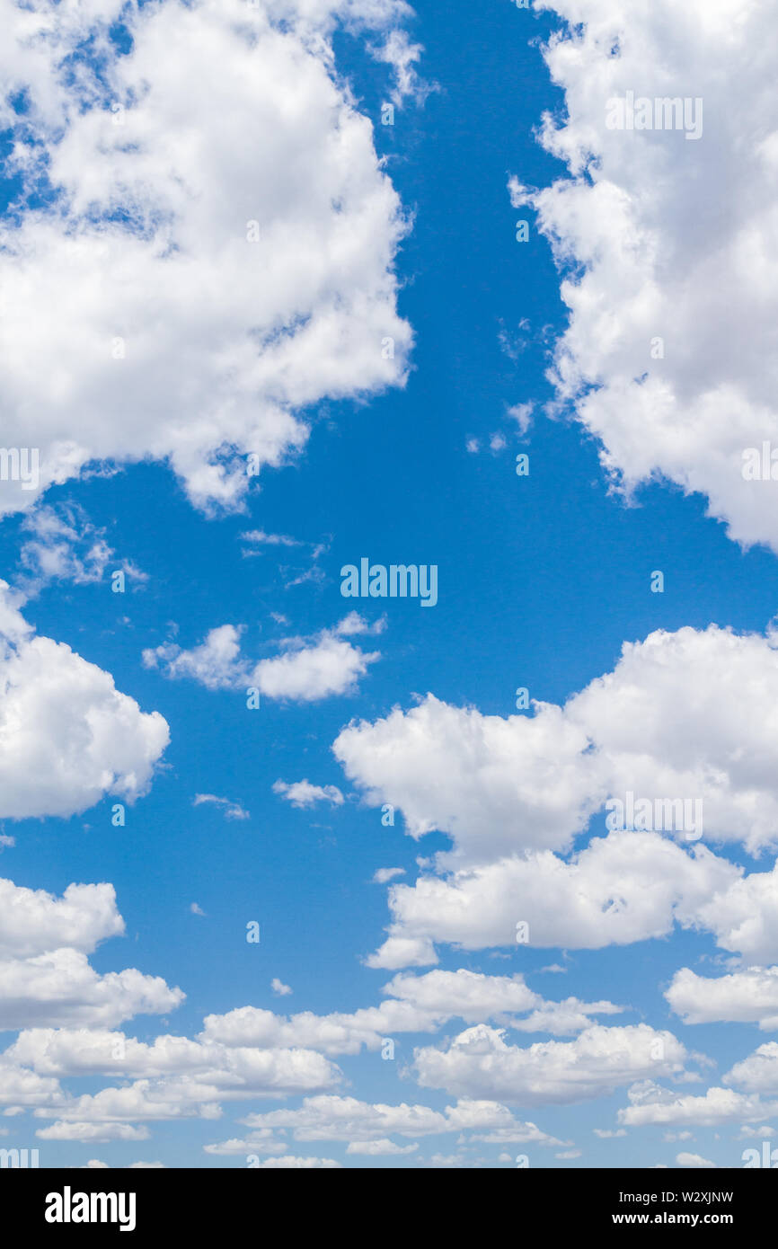 White fluffy clouds in the blue sky in summer Stock Photo - Alamy
