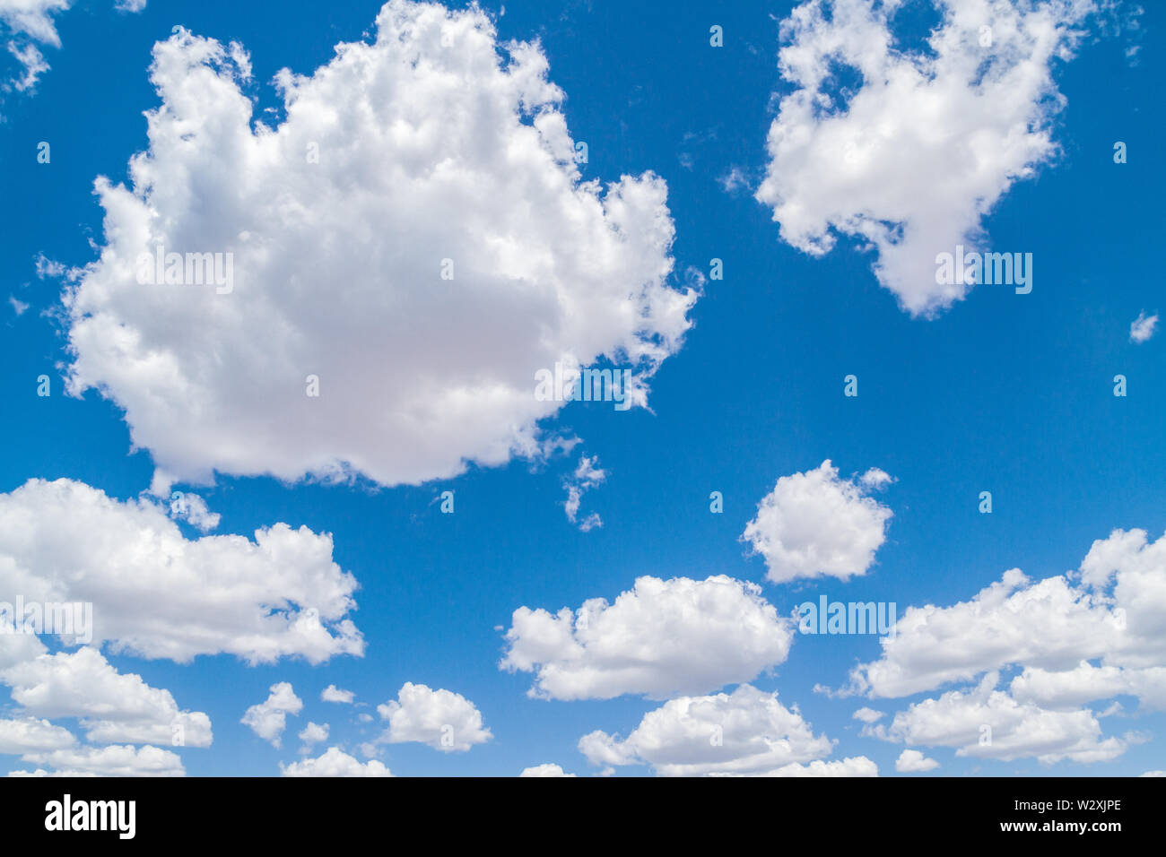 White fluffy clouds in the blue sky in summer Stock Photo - Alamy