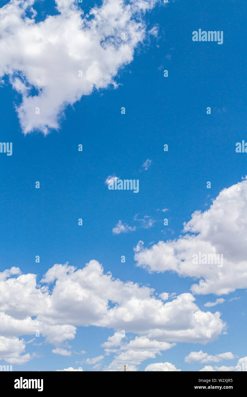 White fluffy clouds in the blue sky in summer Stock Photo - Alamy
