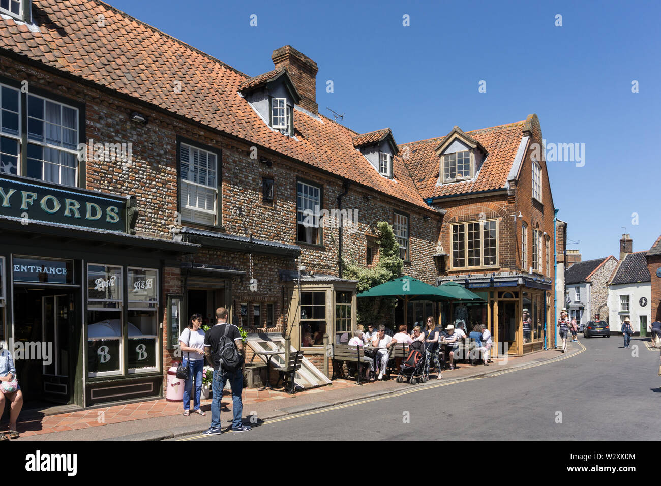Byfords cafe, Holt, Norfolk, UK; customers sitting outside on a sunny Summer's day. Stock Photo