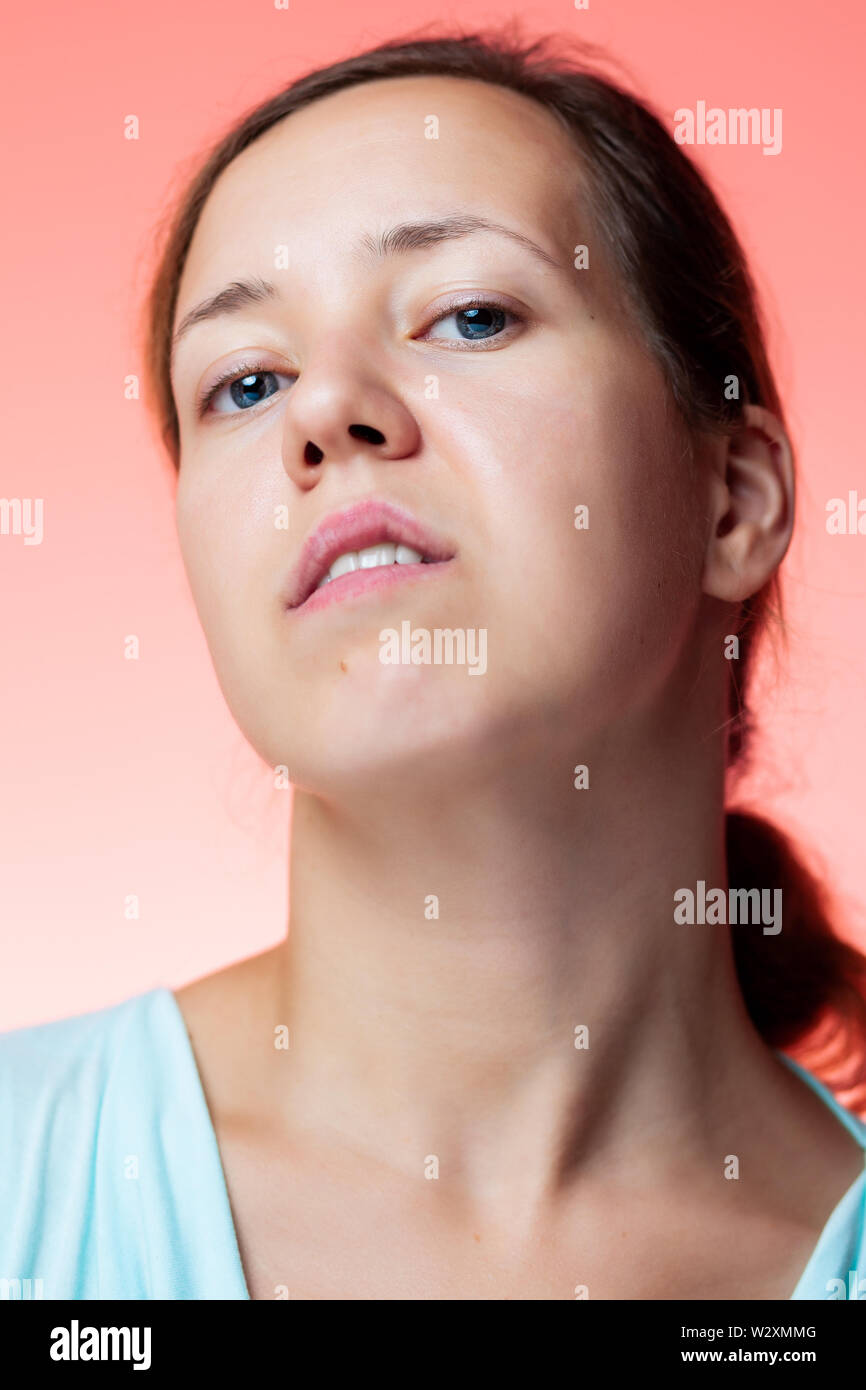 Portrait of an arrogant woman in the studio with isolated pink background Stock Photo