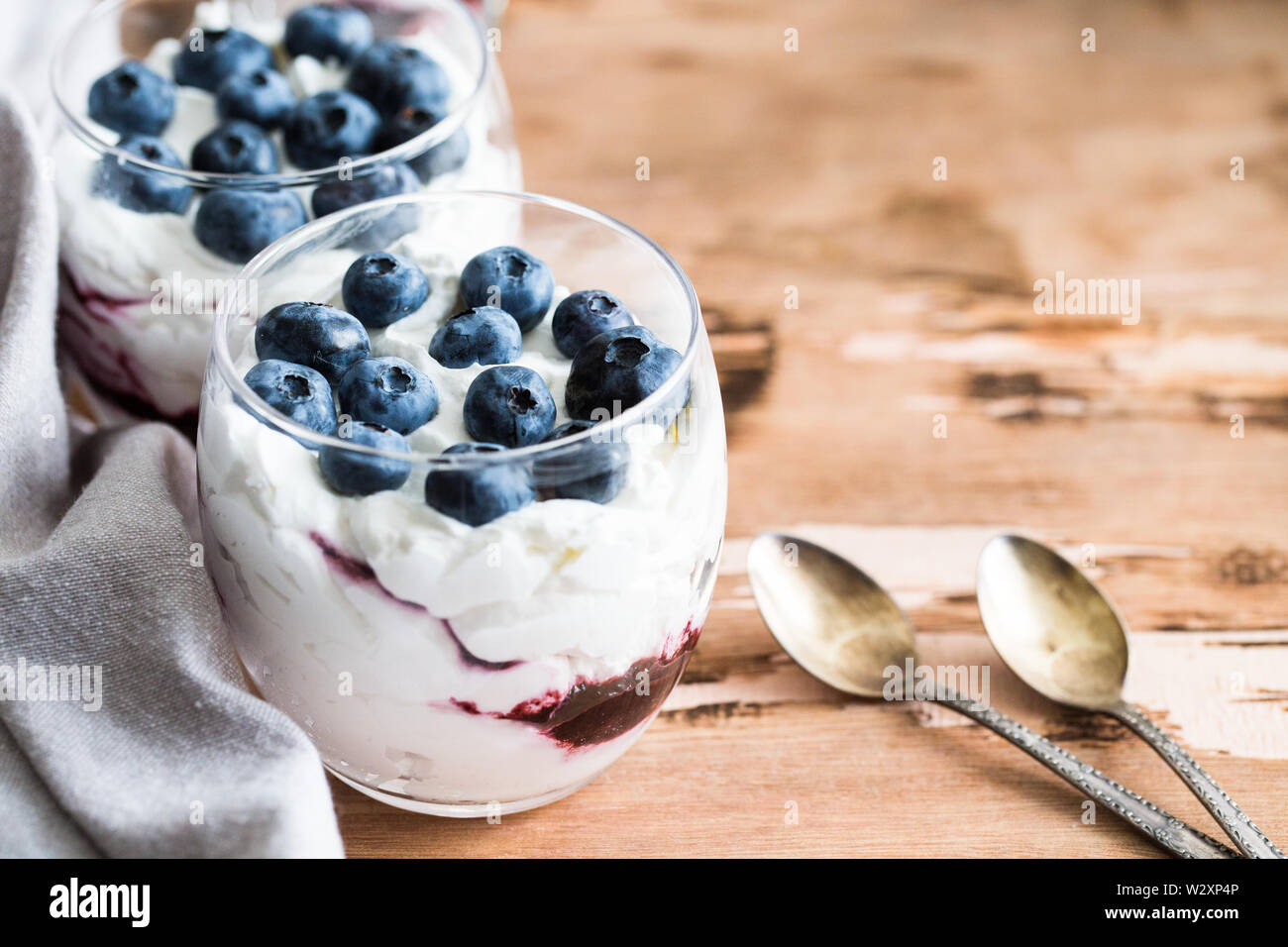 homemade dessert with Greek yoghurt and cream, blueberry jam and fresh