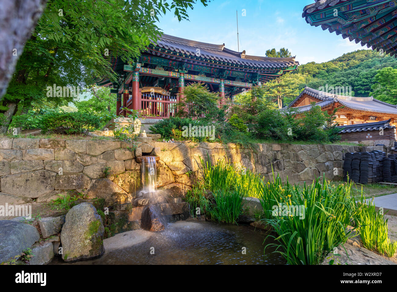 Small waterfall and traditional monastic buildings at Jijiksa Monastery ...