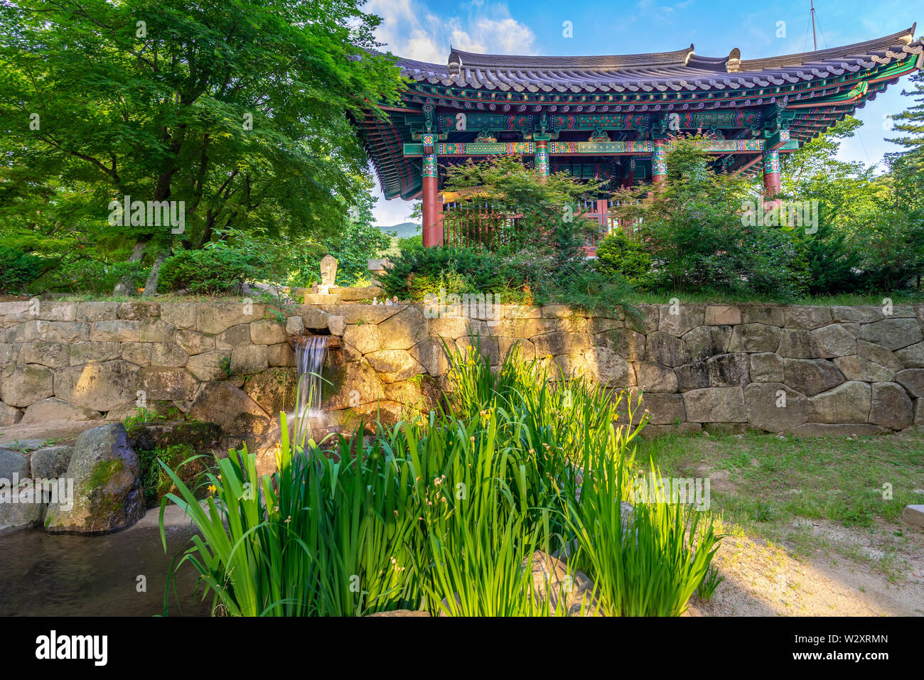 Small waterfall and traditional monastic buildings at Jijiksa Monastery ...