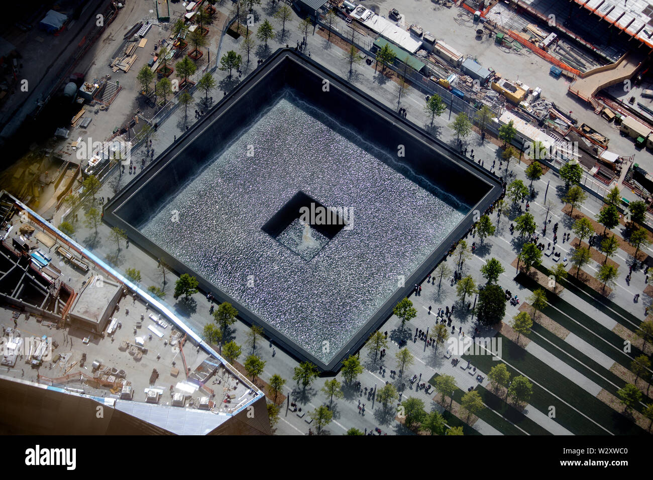 The reflecting pools in the 9/11 Memorial Park at Ground Zero as seen from the 73rd floor of the WTC Tower under construction. Stock Photo