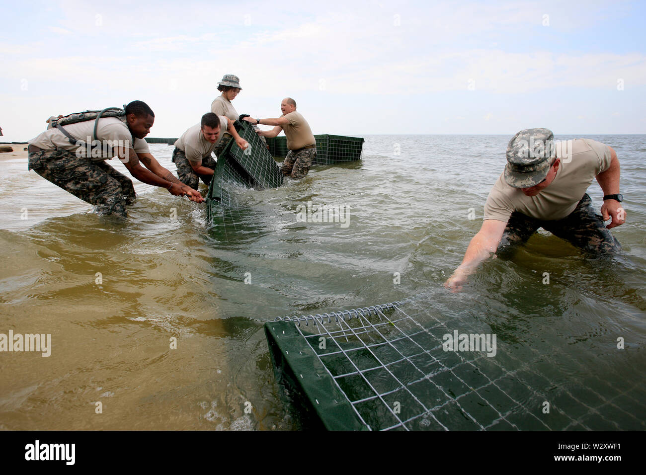 Soldiers from the National Guard 711 Brigade Support Batallion install barriers on the inside shore of the Dauphin Islands. The barriers will be filled with polymers that turn any oil spill into a rubberlike solid. The State of Alabama hope to avoid severe damage to the island from the oil spill caused by the Deepwater Horizon explosion and blowout. Stock Photo