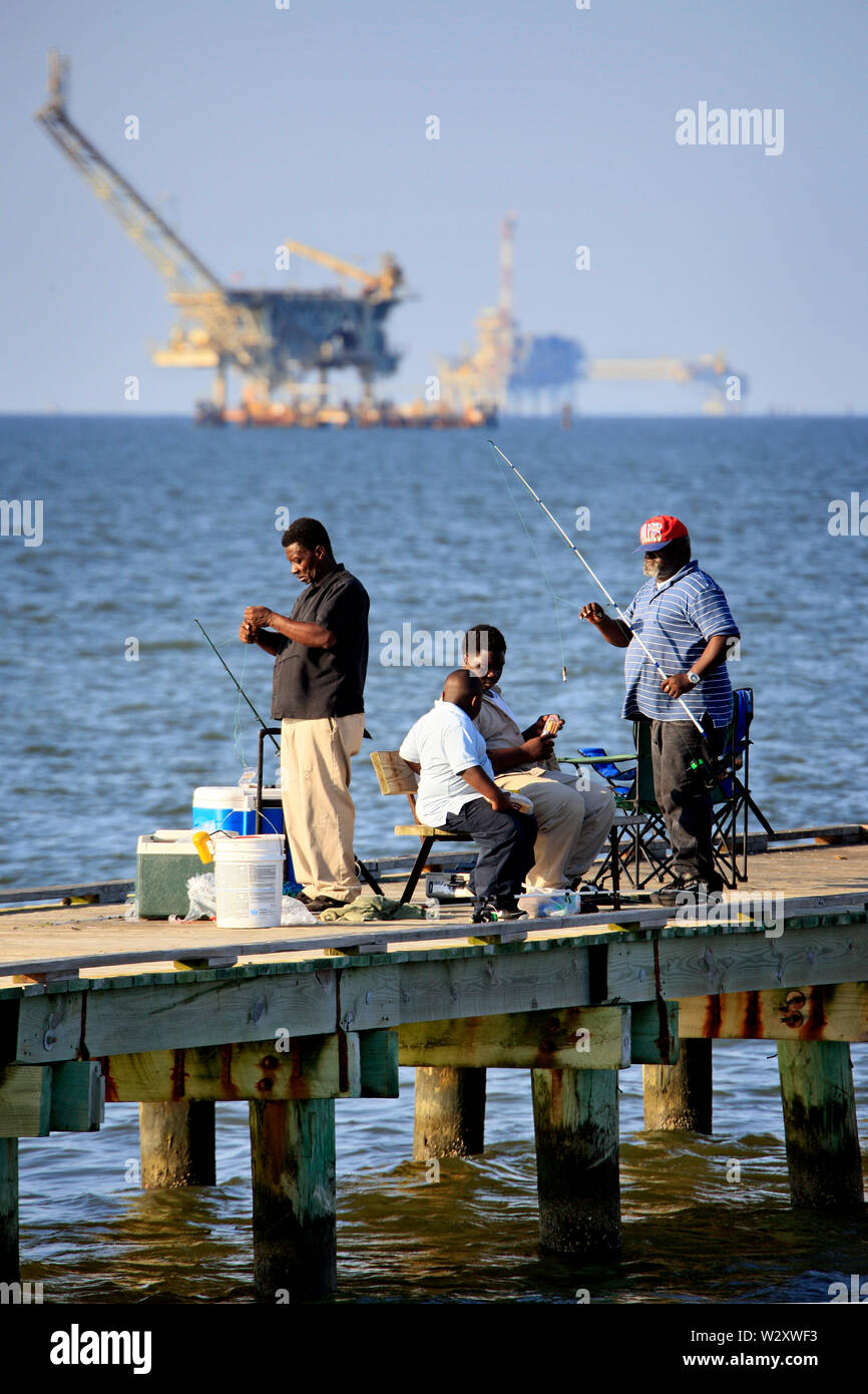 Residents of Dauphin Island go fishing on the pier, undisturbed by the