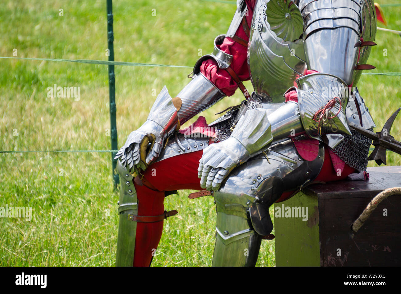 A knight sitting wearing shiny armour Stock Photo