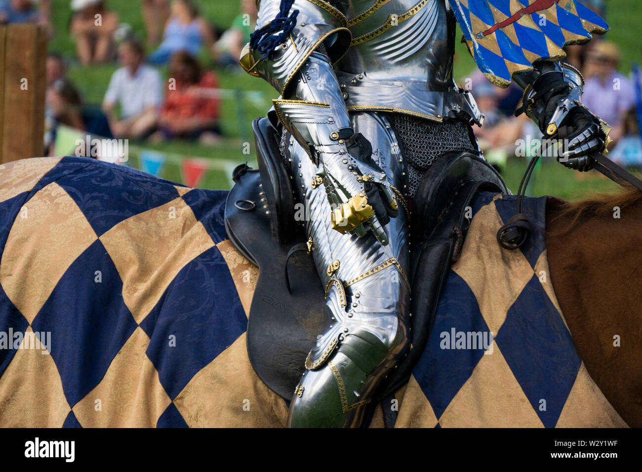 A medieval knight sitting on a horse wearing shining armour Stock Photo
