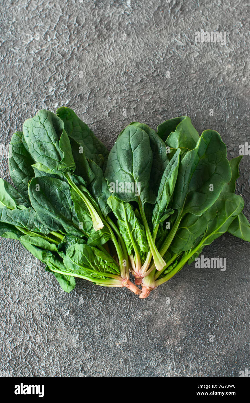 Fresh spinach leaves on a gray background Stock Photo - Alamy