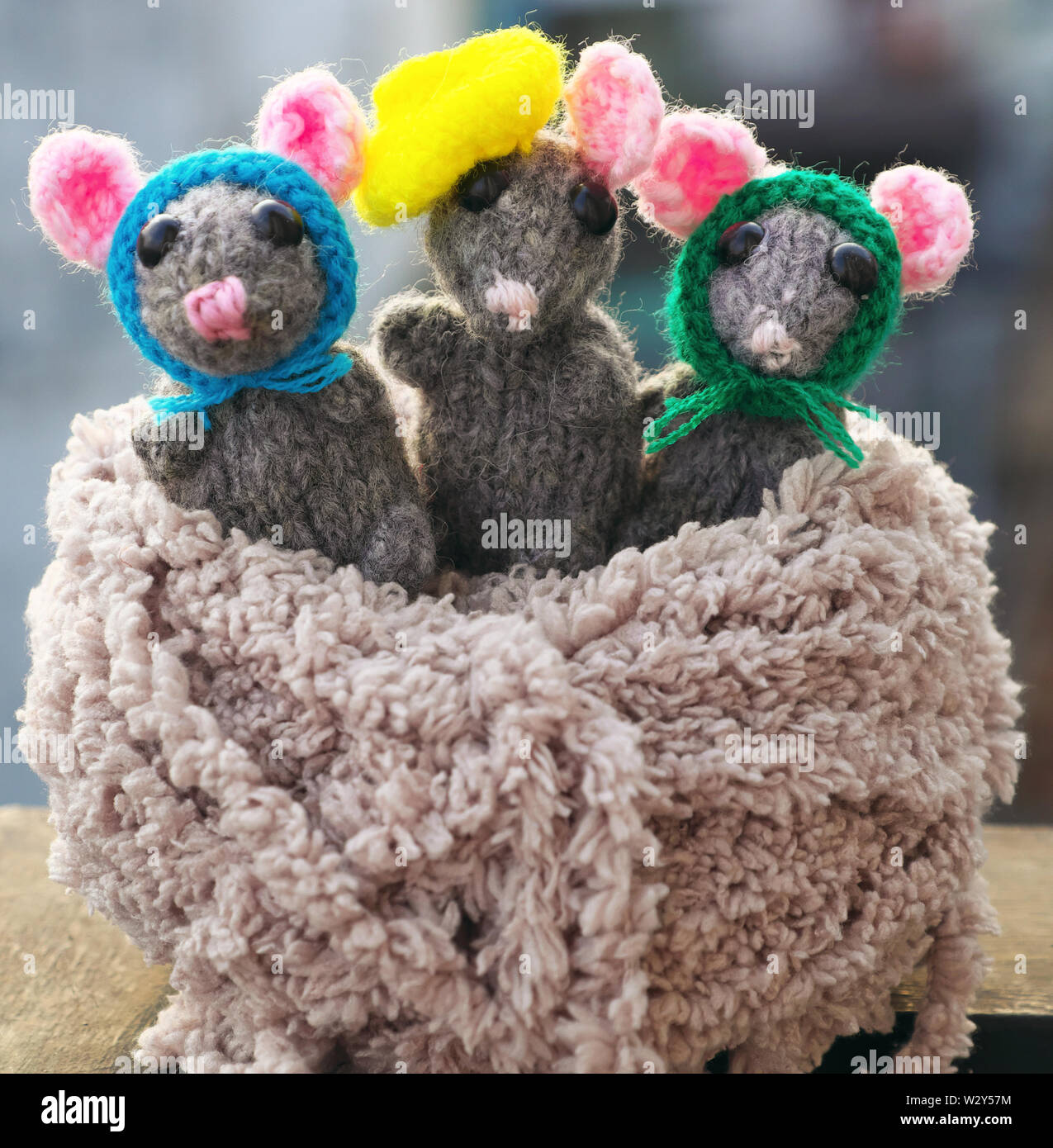 Amazing close up shooting of handmade product,knitted mouse in ball of yarn, blurred background, handicraft rats for nice gift or children toys Stock Photo