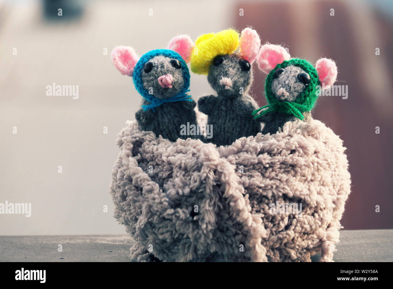 Amazing close up shooting of handmade product,knitted mouse in ball of yarn, blurred background, handicraft rats for nice gift or children toys Stock Photo