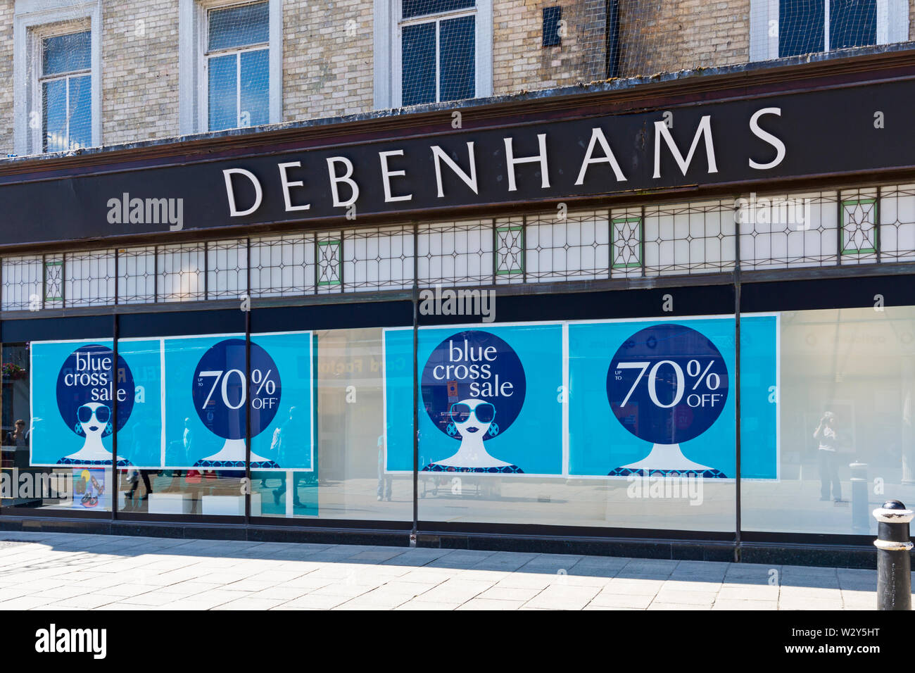 Debenhams store shop with blue cross sale up to 70% off advertised in front window at Winchester, Hampshire, UK in July Stock Photo