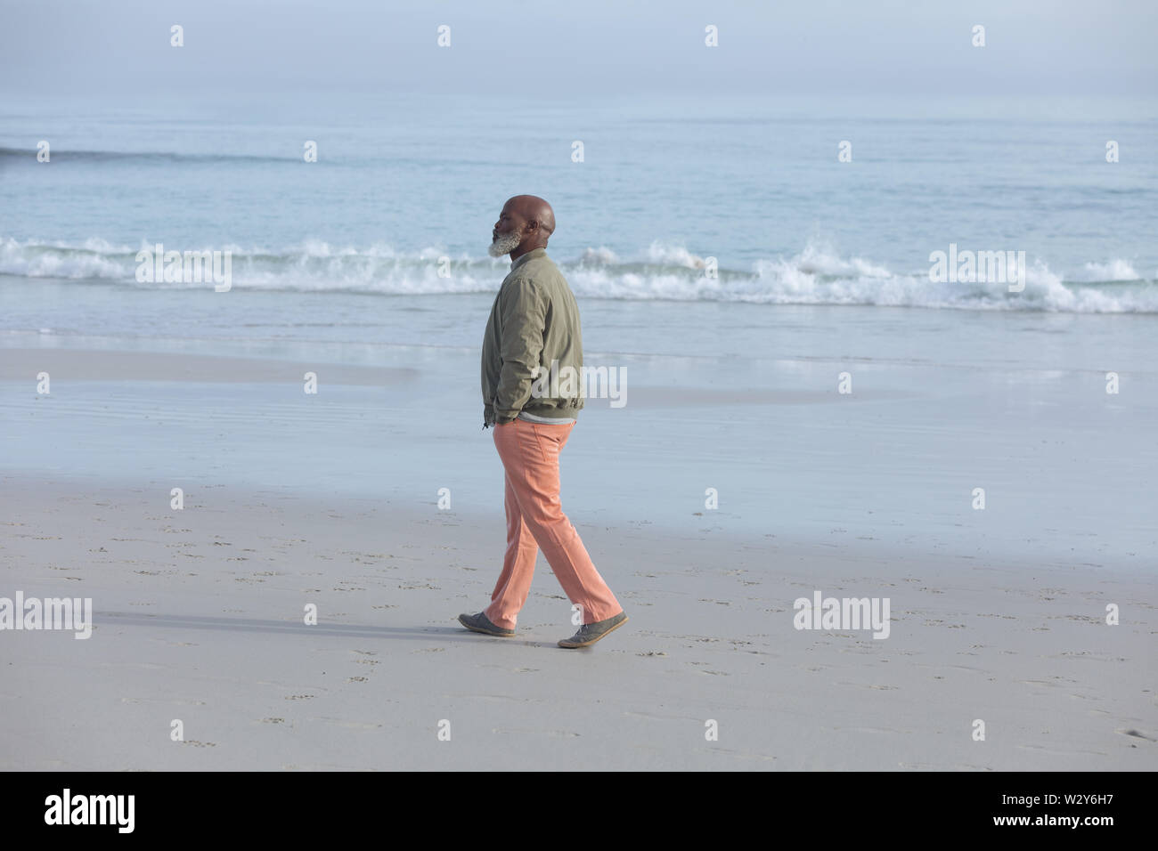 African-American man walking at the beach Stock Photo - Alamy