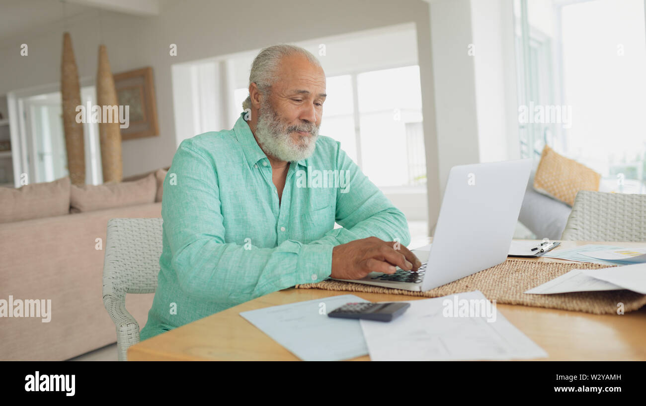 Man using laptop on table Stock Photo