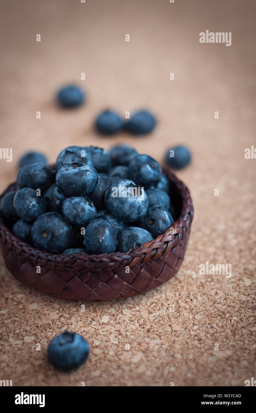 Freshly picked blueberries in woven natural screw pine leaf bowl. Juicy