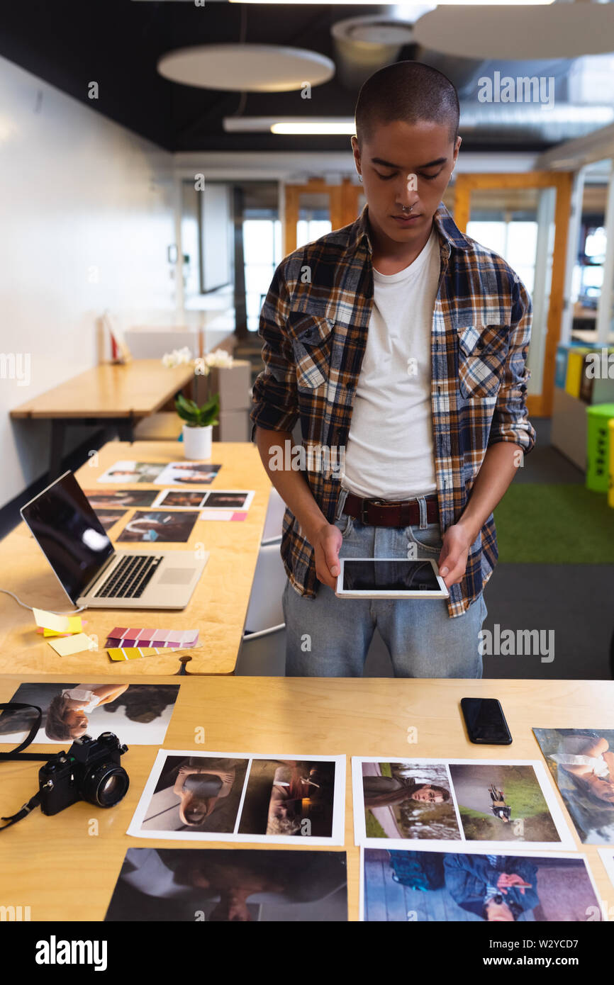 Male graphic designer using digital tablet at desk Stock Photo