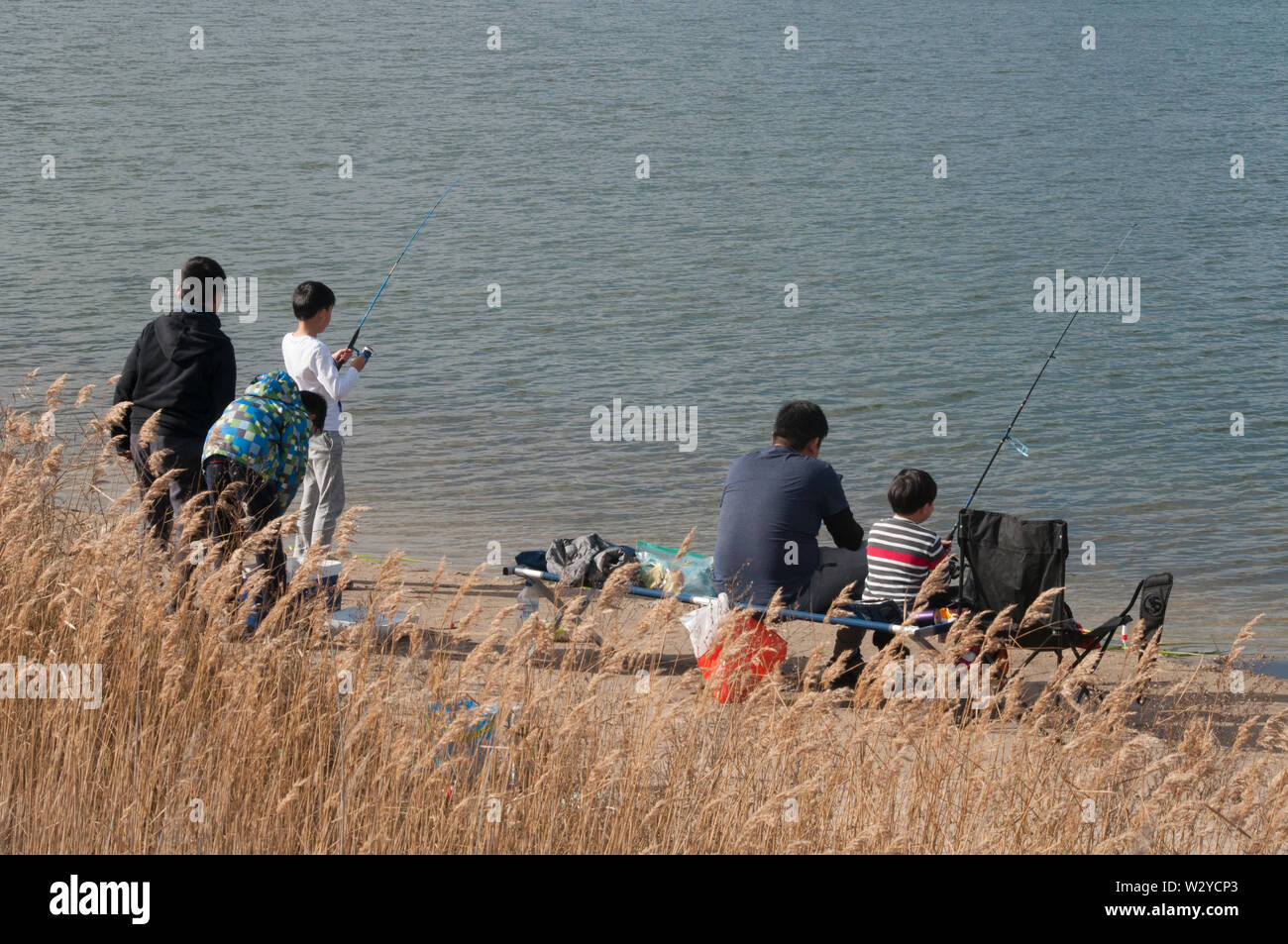 Families fishing at Karkarook Park, Moorabbin, Victoria, a former sand quarry in the eastern suburbs of Melbourne, Australia Stock Photo
