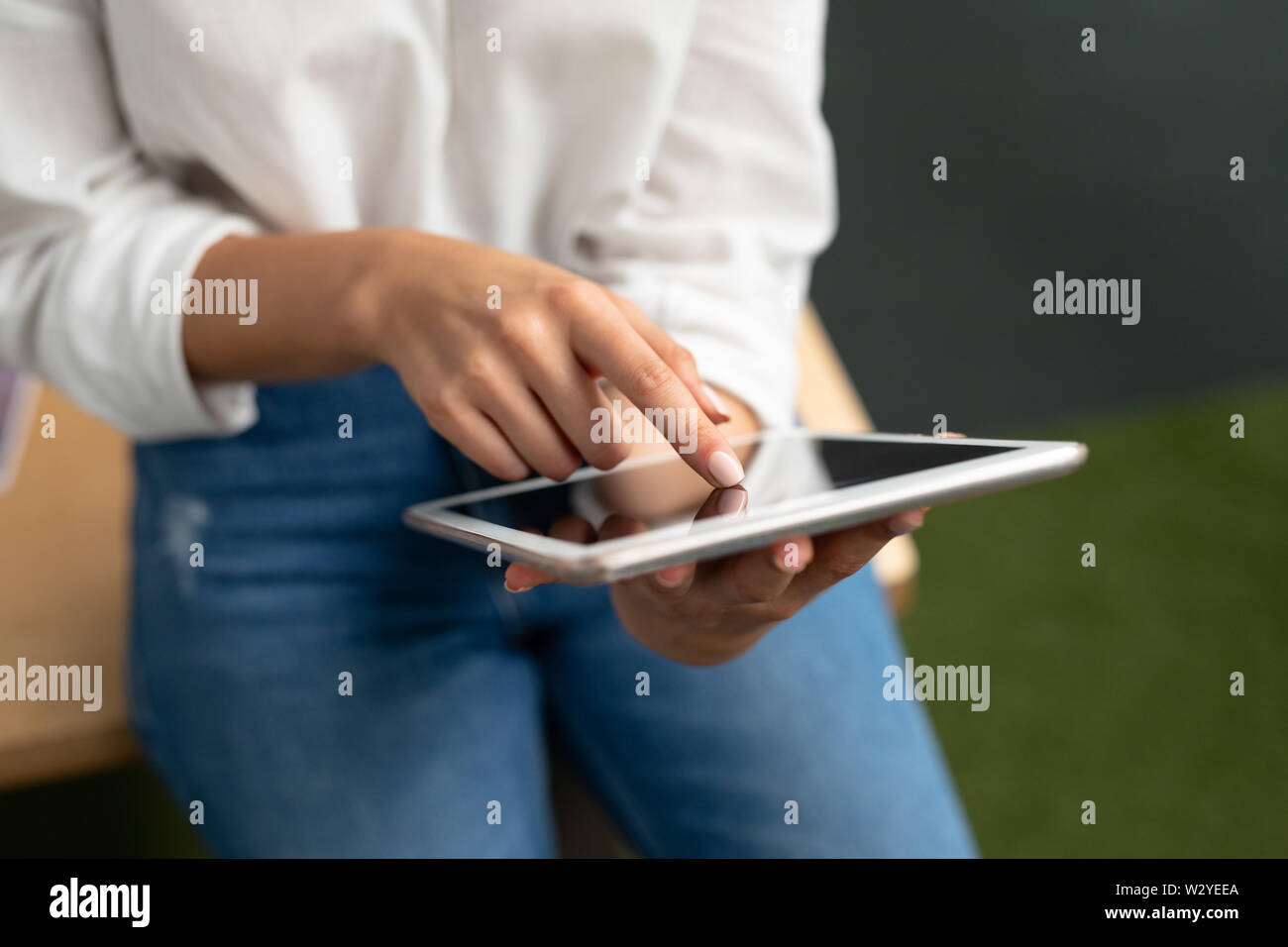 Female graphic designer using digital tablet at desk Stock Photo