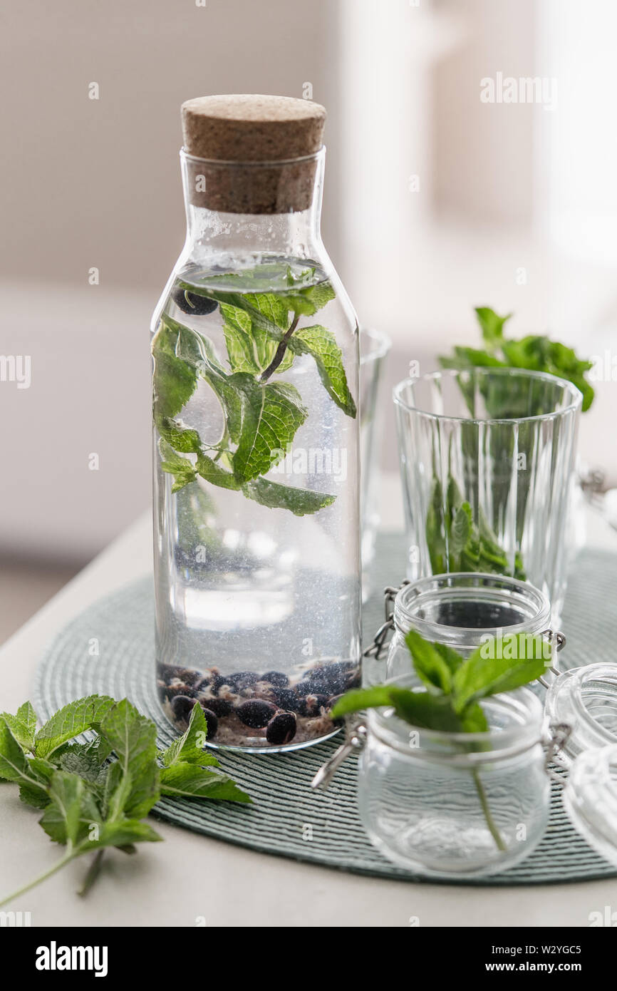 Infused Water Fresh Mint Leaves And Black Currant Berries In A Glass Bottle Stock Photo Alamy