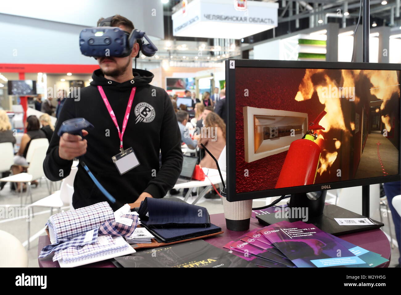 YEKATERINBURG, RUSSIA - JULY 11, 2019: A man in a VR headset uses a firefighting simulator at the 2019 Innoprom International Industrial Trade Fair, at the Yekaterinburg-Expo Exhibition Centre. Yegor Aleyev/TASS - Stock Image
