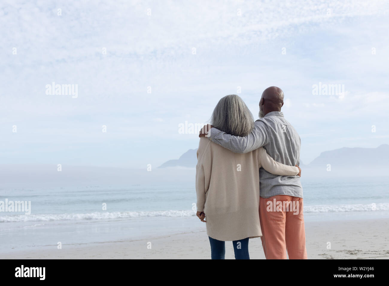 Couple standing on the beach. Stock Photo